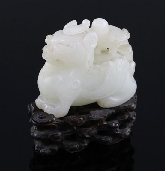A Chinese white jade figure of bixi with a bird on its back, 17th/18th century, L. 5.4cm, wood stand